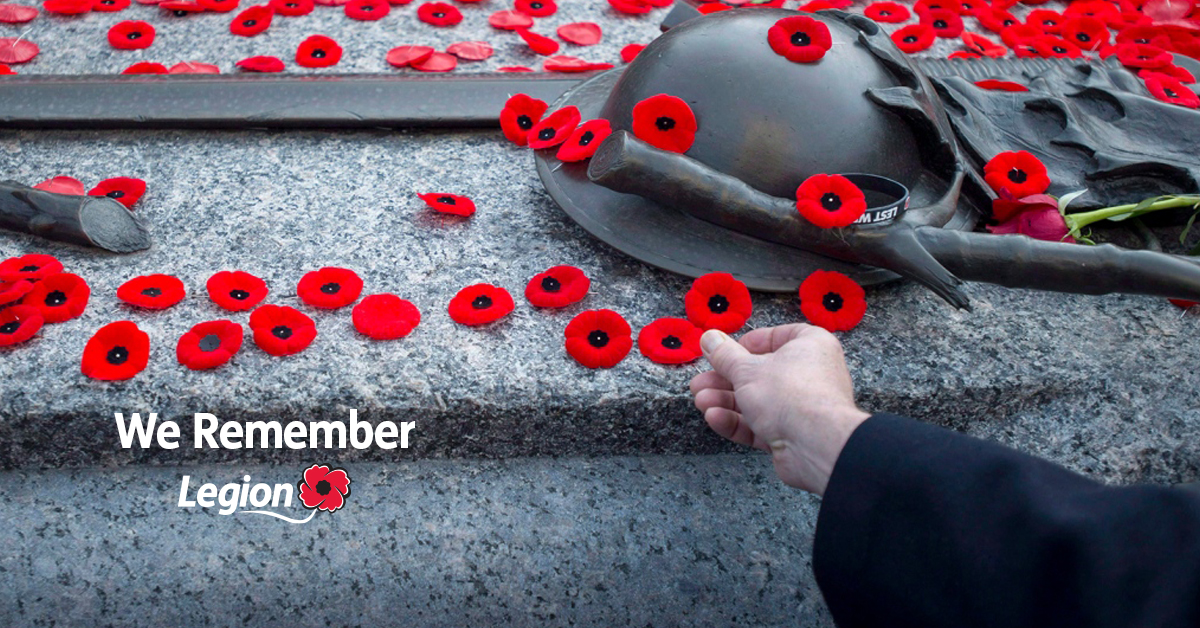Remembrance Day graphic showing poppies on a granite step beside a soldier's helmet